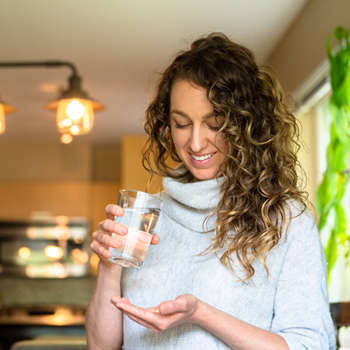 A Woman Taking Vitamin Supplements